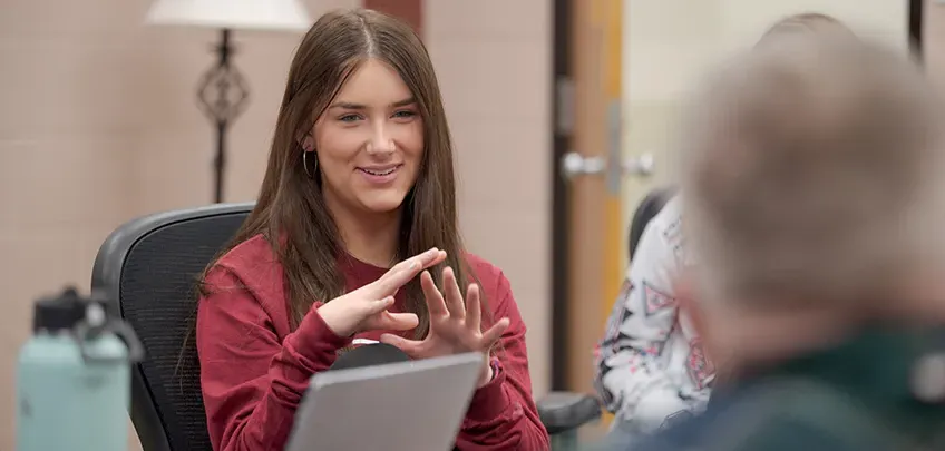 An education student engages in a group discussion